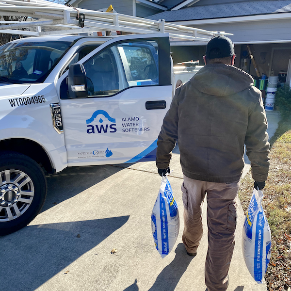 Alamo Water Softeners team member delivering salt bags to customers home