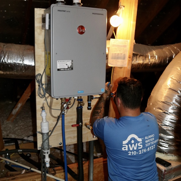 Alamo Water Softeners team member installing a new Rheem tankless hot water heater