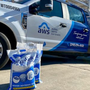 Alamo Water Softeners technician carrying and delivering two bags of water softener salt
