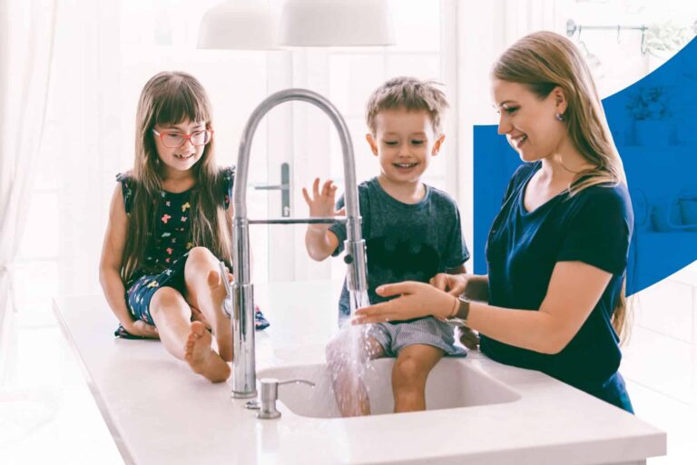 family washing their hands at the kitchen sink